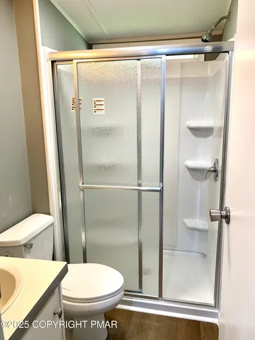 a bathroom with a glass shower door
