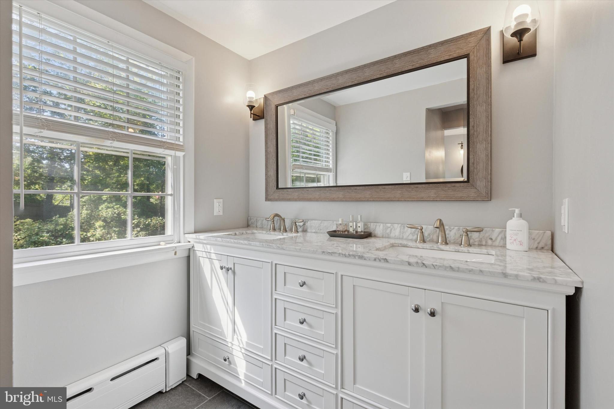 711 Custis Road Glenside, PA 19038 - Photo 23 of 53 a bathroom with double sink and a mirror