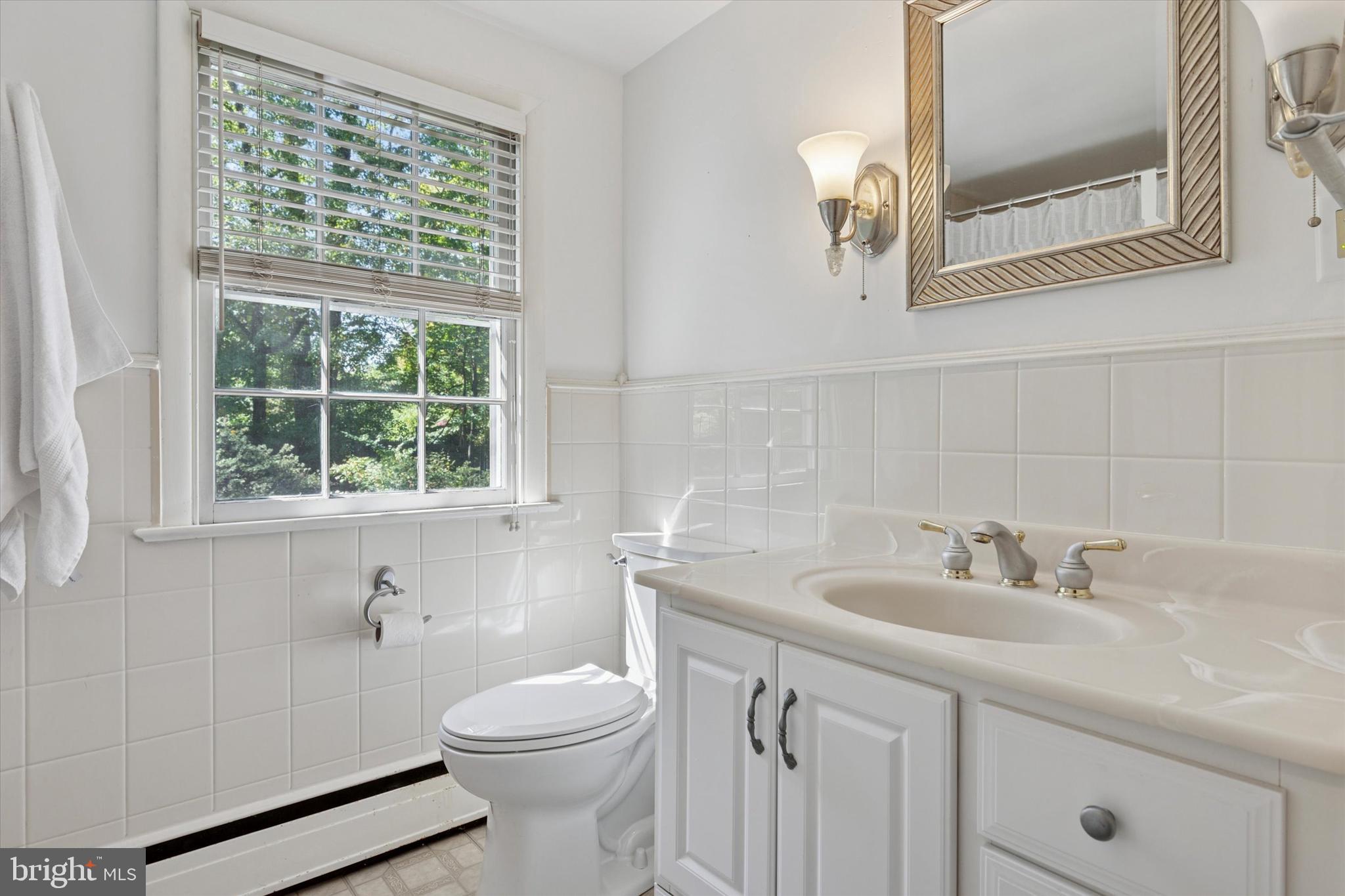 711 Custis Road Glenside, PA 19038 - Photo 34 of 53 a bathroom with a sink a toilet and a mirror