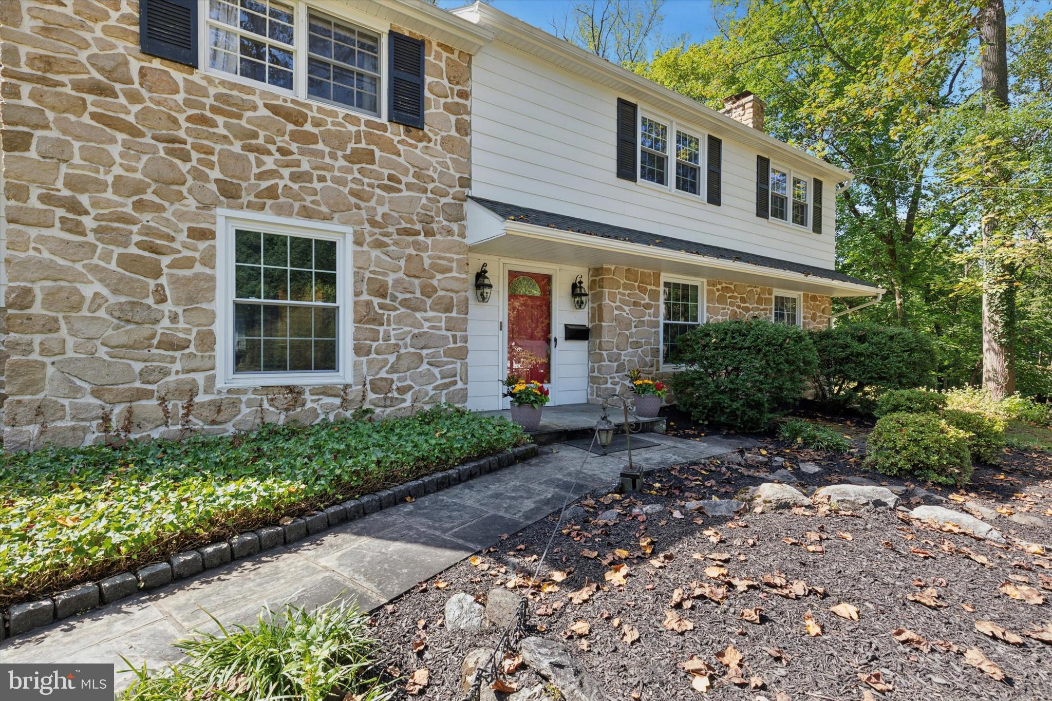 711 Custis Road Glenside, PA 19038 - Photo 45 of 53 a view of a brick house with large windows and flower plants