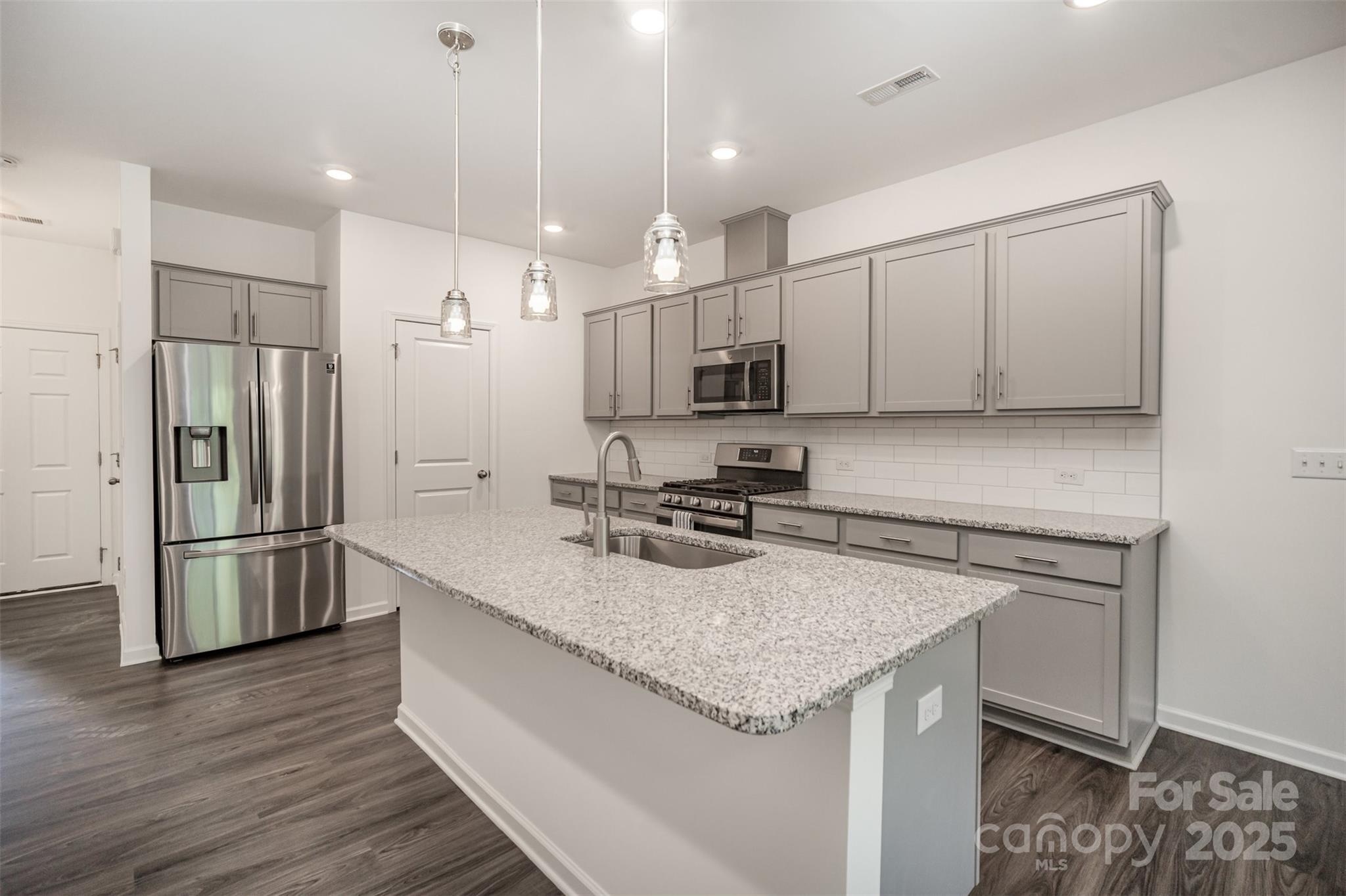 558 Dulaney Drive Tega Cay, SC 29708 - Photo 12 of 30 a kitchen with stainless steel appliances granite countertop a sink stove and refrigerator