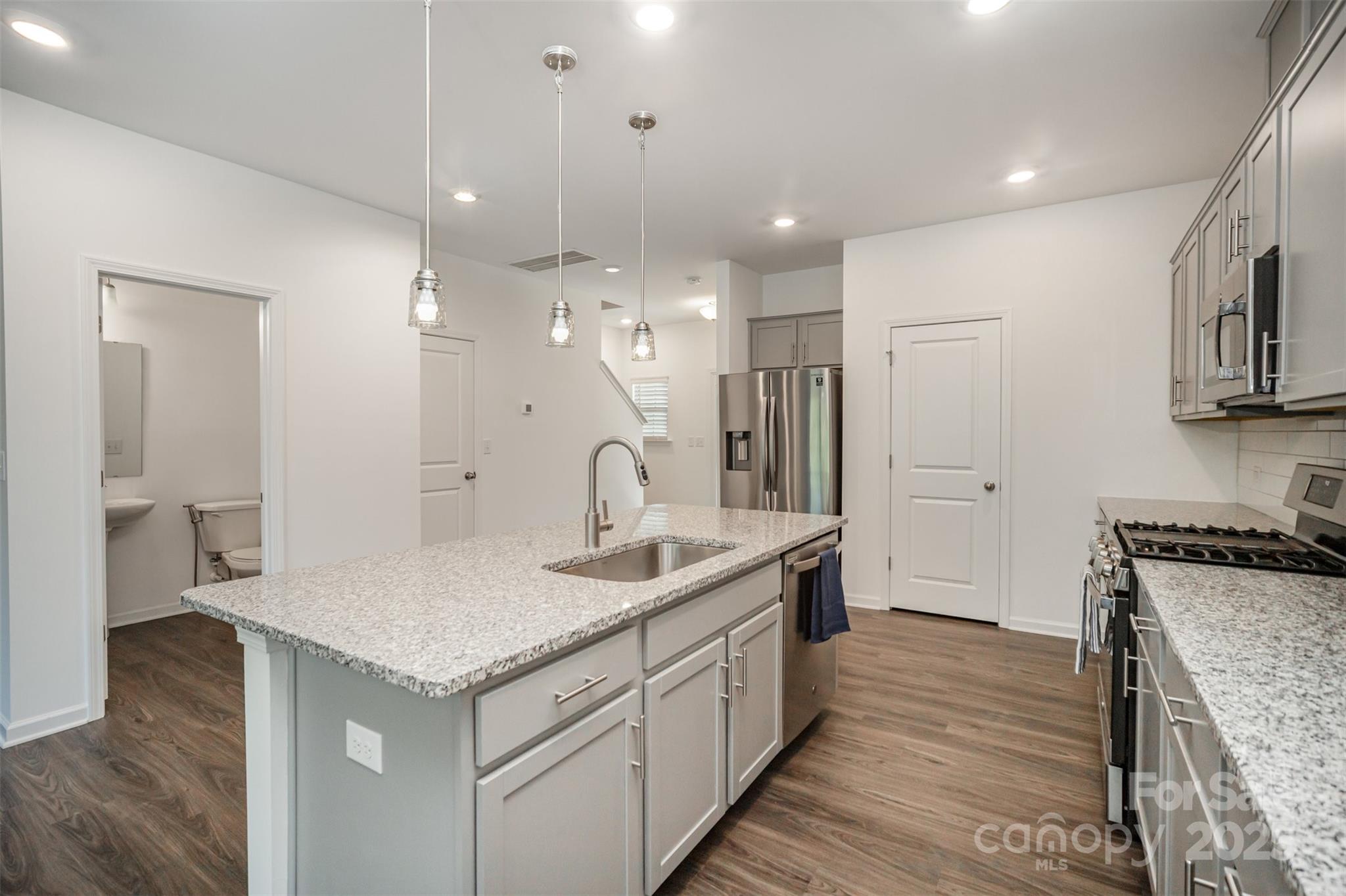 558 Dulaney Drive Tega Cay, SC 29708 - Photo 13 of 30 a kitchen with granite countertop a sink a counter space appliances and cabinets