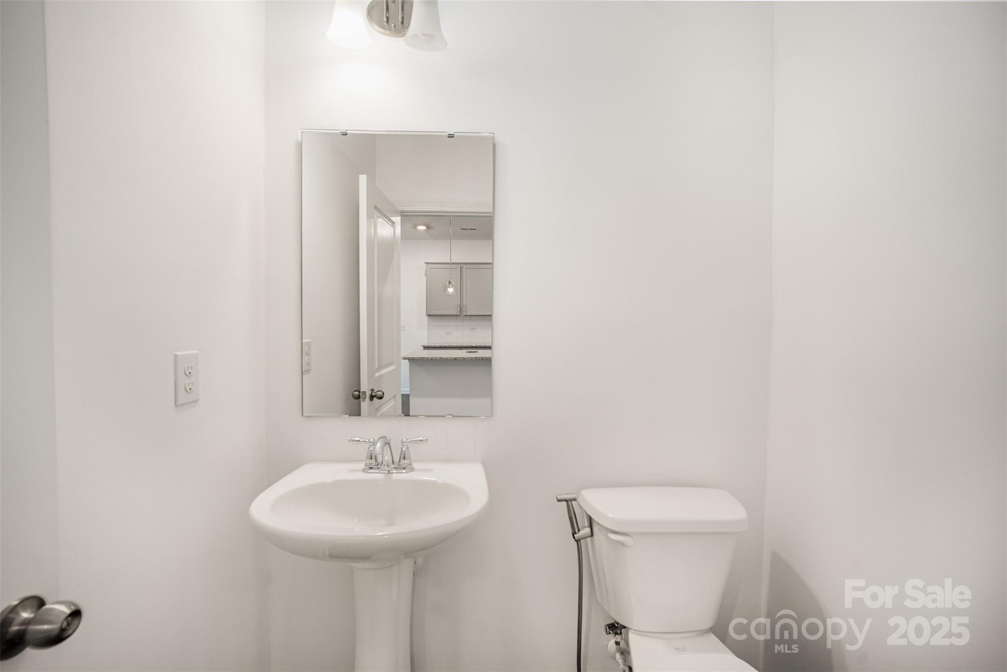 558 Dulaney Drive Tega Cay, SC 29708 - Photo 15 of 30 a bathroom with a sink a toilet and mirror