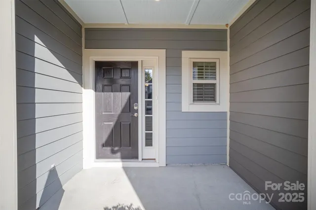 a view of a livingroom with wooden floor and a fireplace
