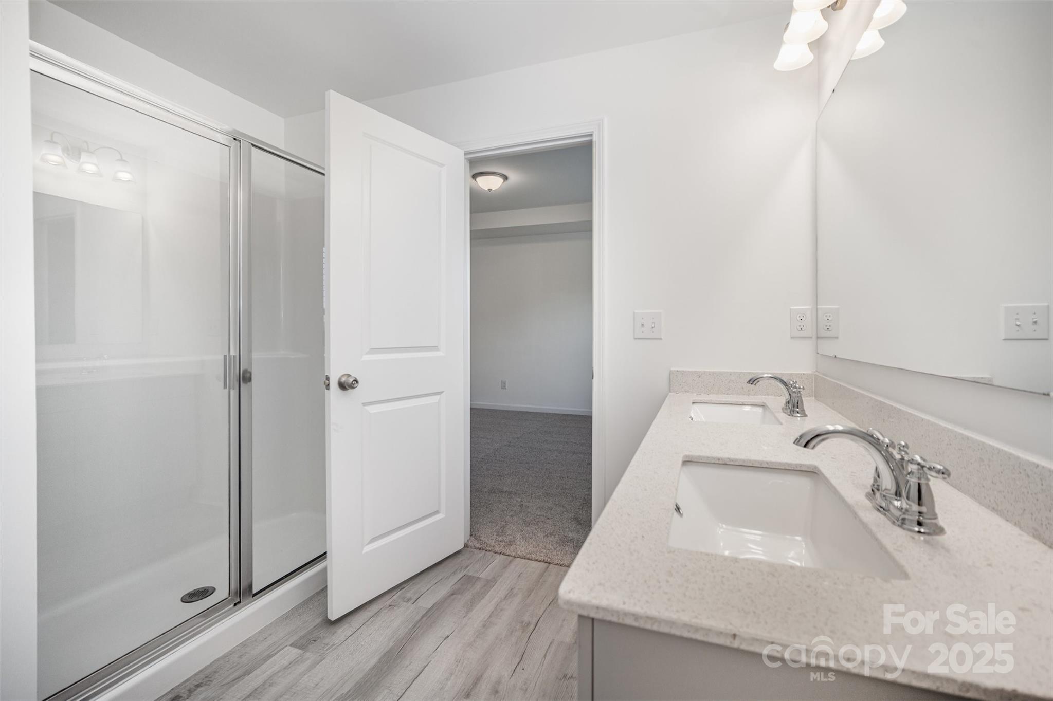 558 Dulaney Drive Tega Cay, SC 29708 - Photo 22 of 30 a bathroom with a sink and a large mirror