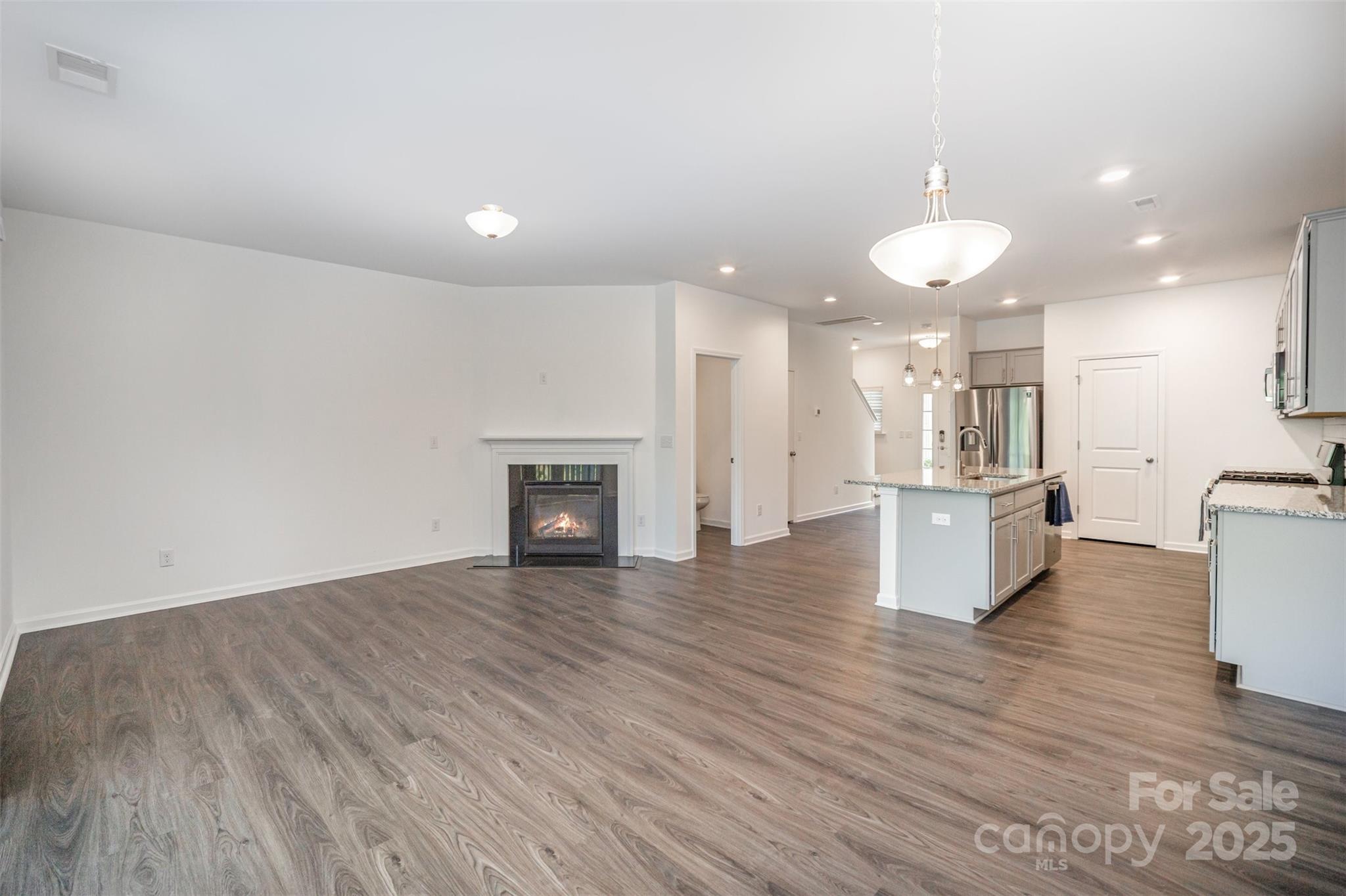 558 Dulaney Drive Tega Cay, SC 29708 - Photo 3 of 30 a view of kitchen and hall with wooden floor