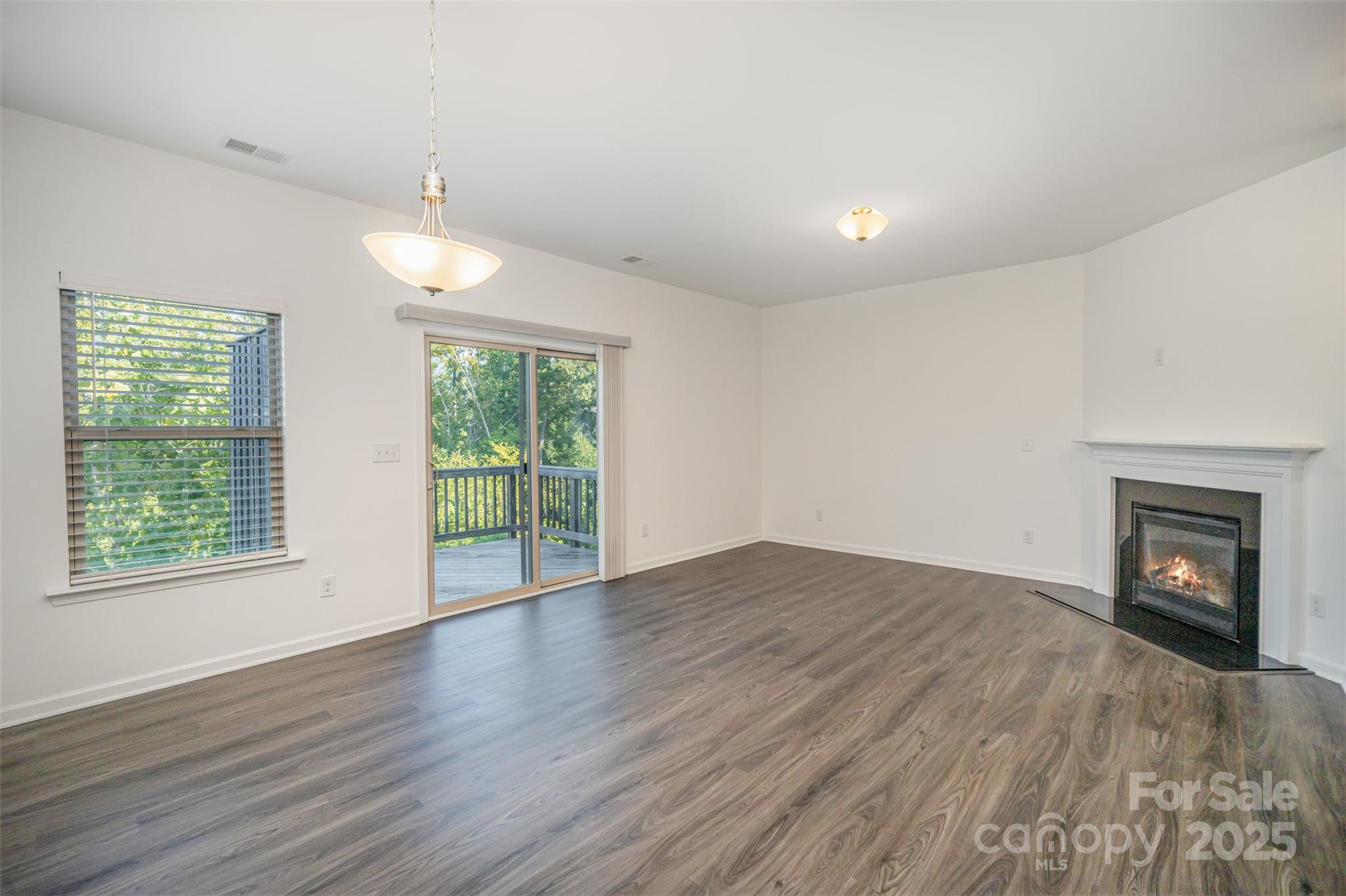 558 Dulaney Drive Tega Cay, SC 29708 - Photo 5 of 30 a view of an empty room with wooden floor and a window