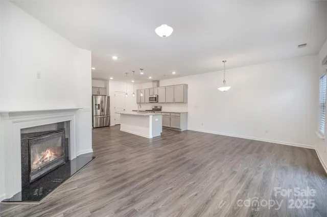 an open kitchen with a sink and dish washer