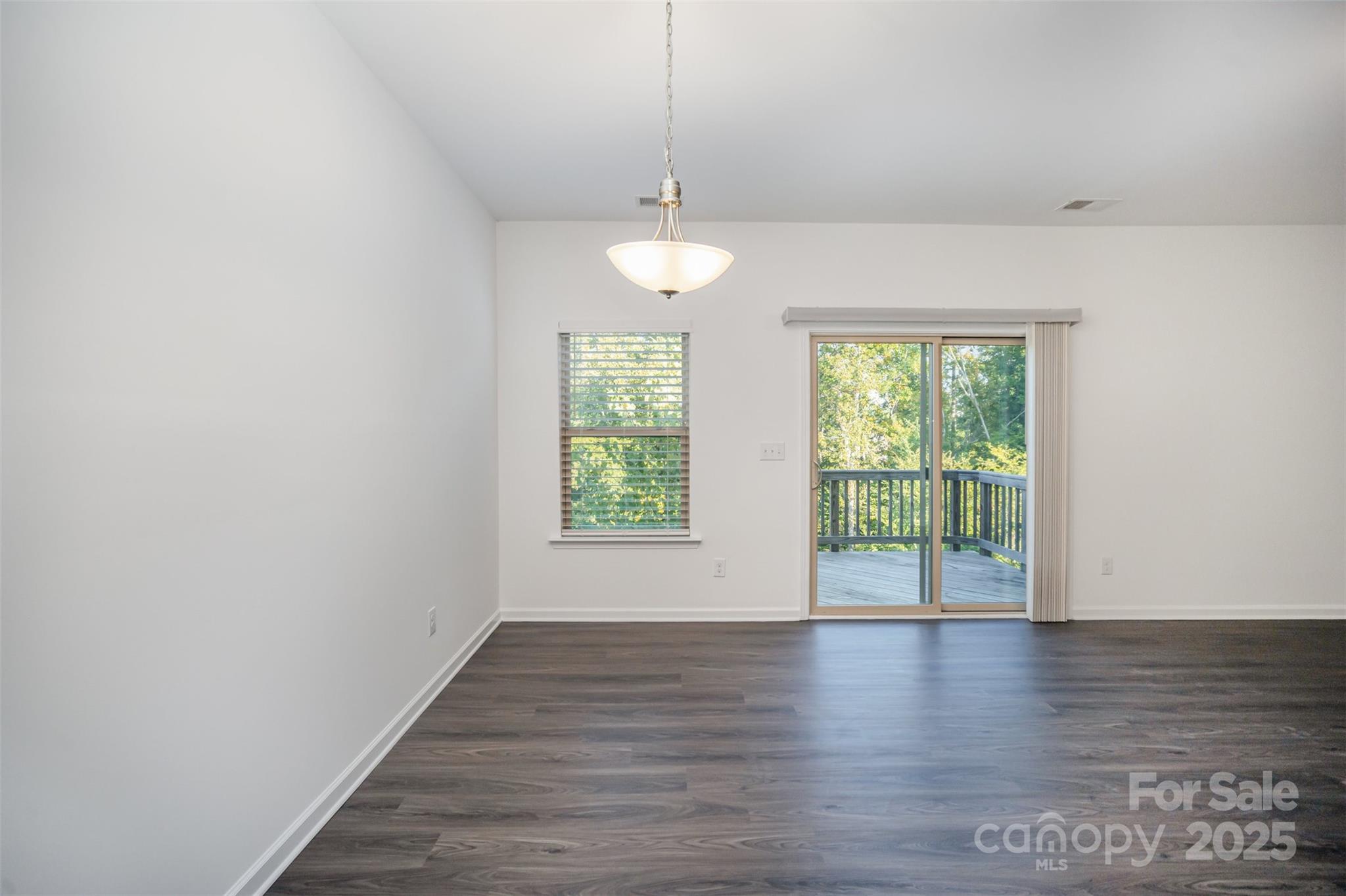 558 Dulaney Drive Tega Cay, SC 29708 - Photo 10 of 30 an empty room with wooden floor and windows