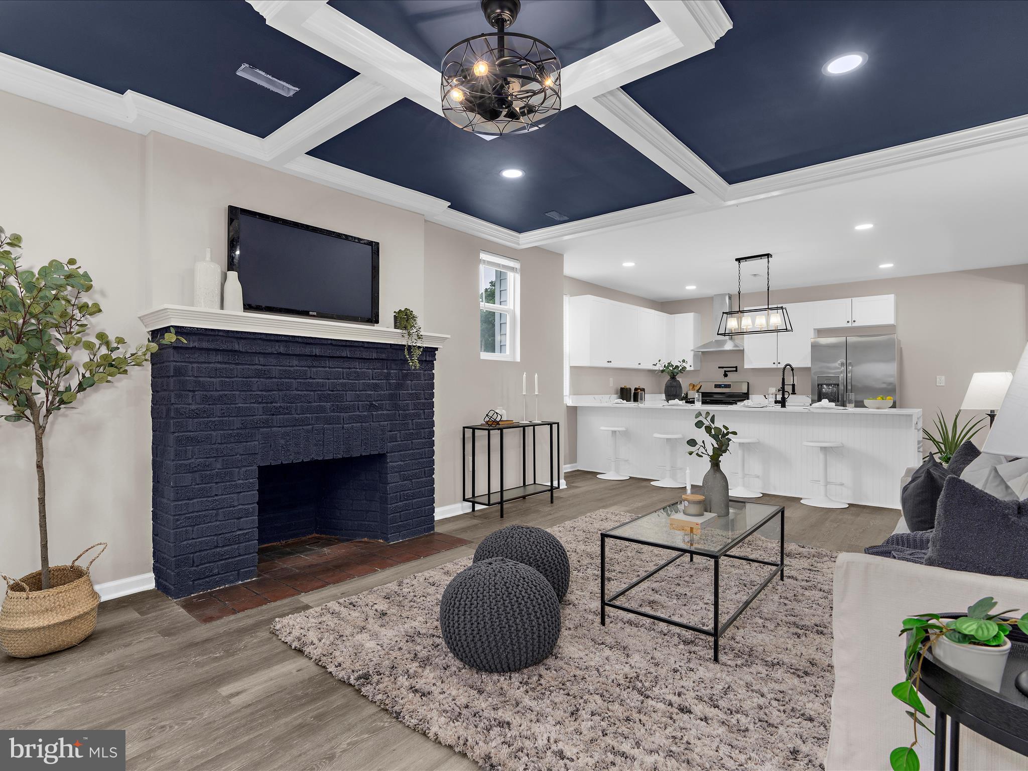 3708 Mohawk Avenue Baltimore, MD 21207 - Photo 1 of 54 a living room with furniture a flat screen tv and kitchen view
