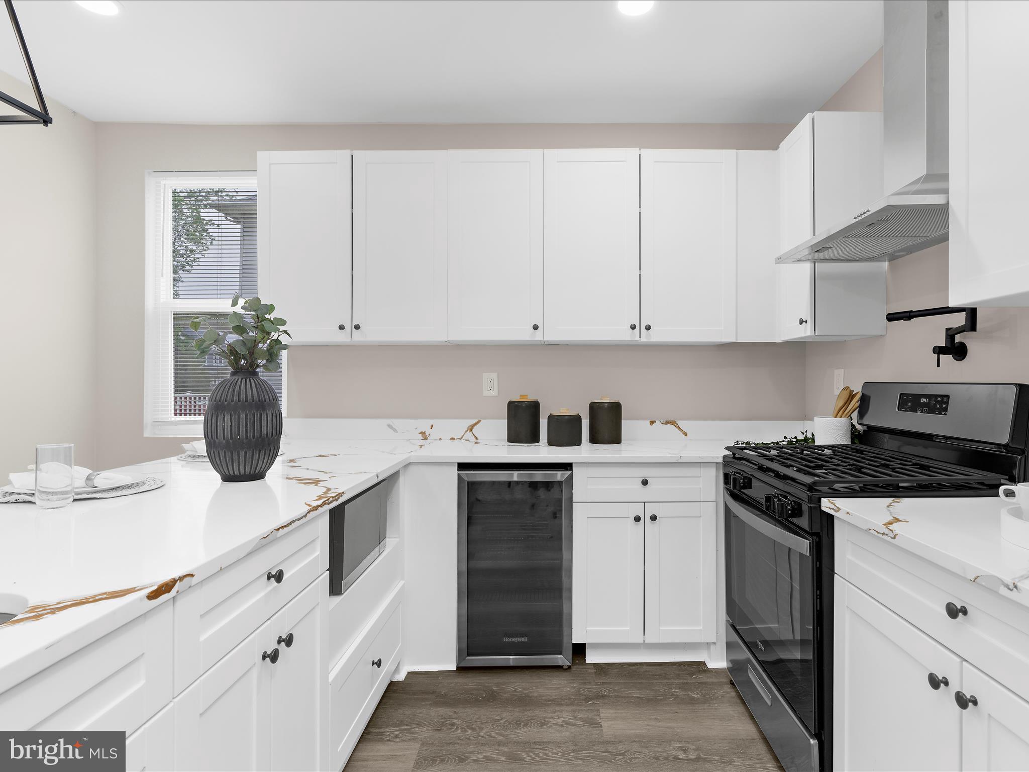 3708 Mohawk Avenue Baltimore, MD 21207 - Photo 13 of 54 a kitchen with white cabinets and appliances