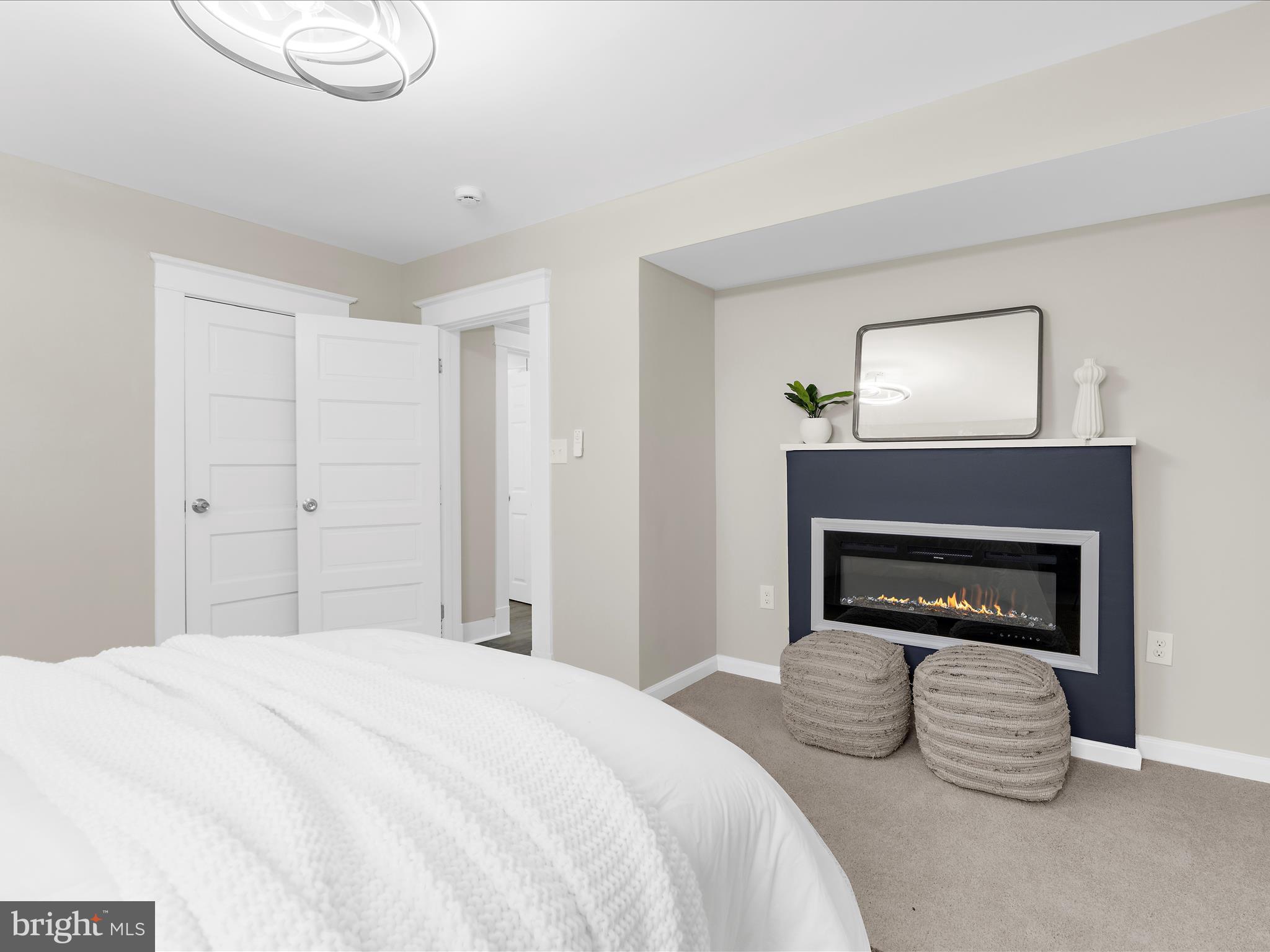 3708 Mohawk Avenue Baltimore, MD 21207 - Photo 22 of 54 a bedroom with a bed and a fireplace