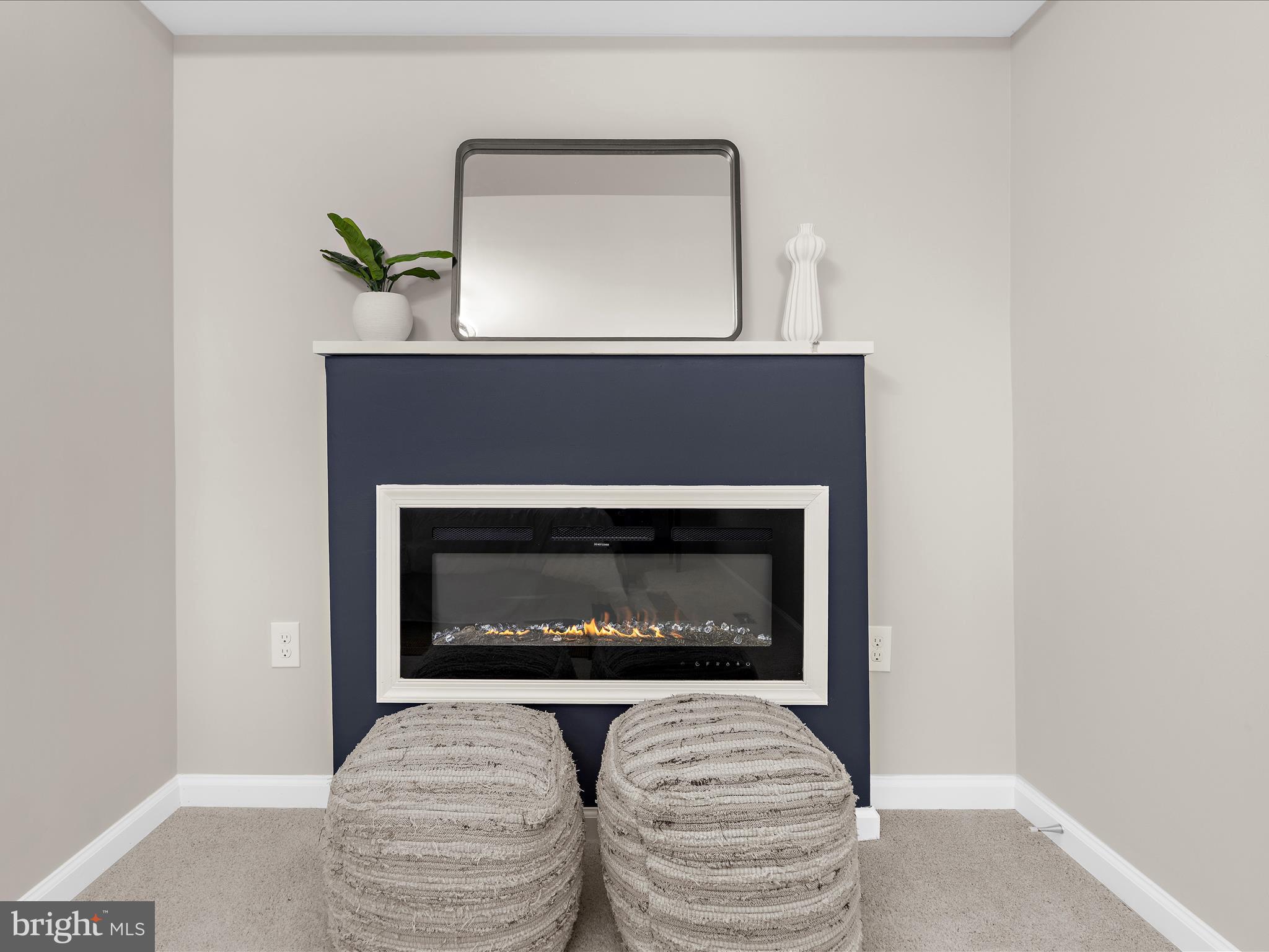 3708 Mohawk Avenue Baltimore, MD 21207 - Photo 23 of 54 a living room with a fireplace and a potted plant