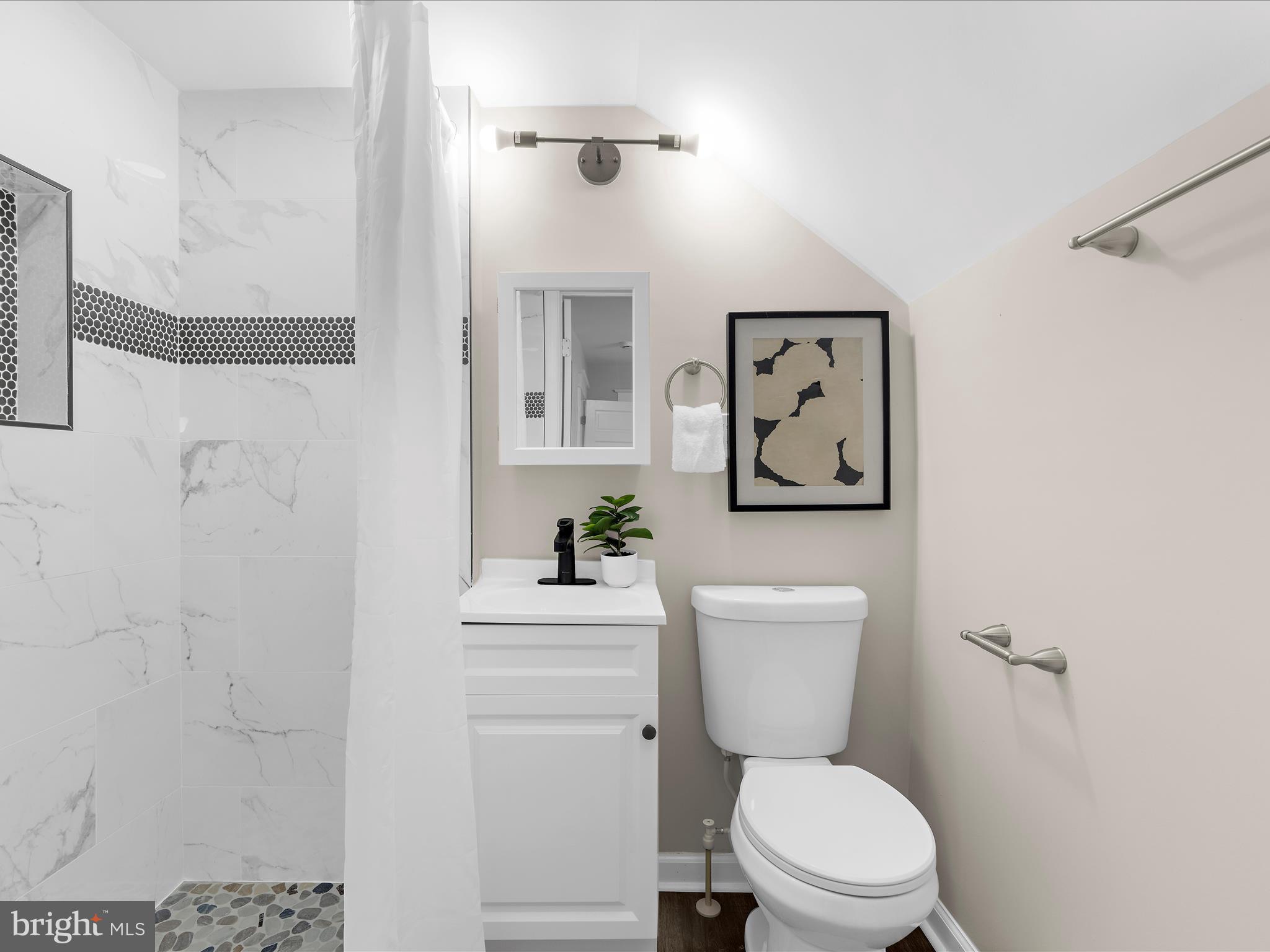 3708 Mohawk Avenue Baltimore, MD 21207 - Photo 24 of 54 a white toilet sitting next to a bathroom sink