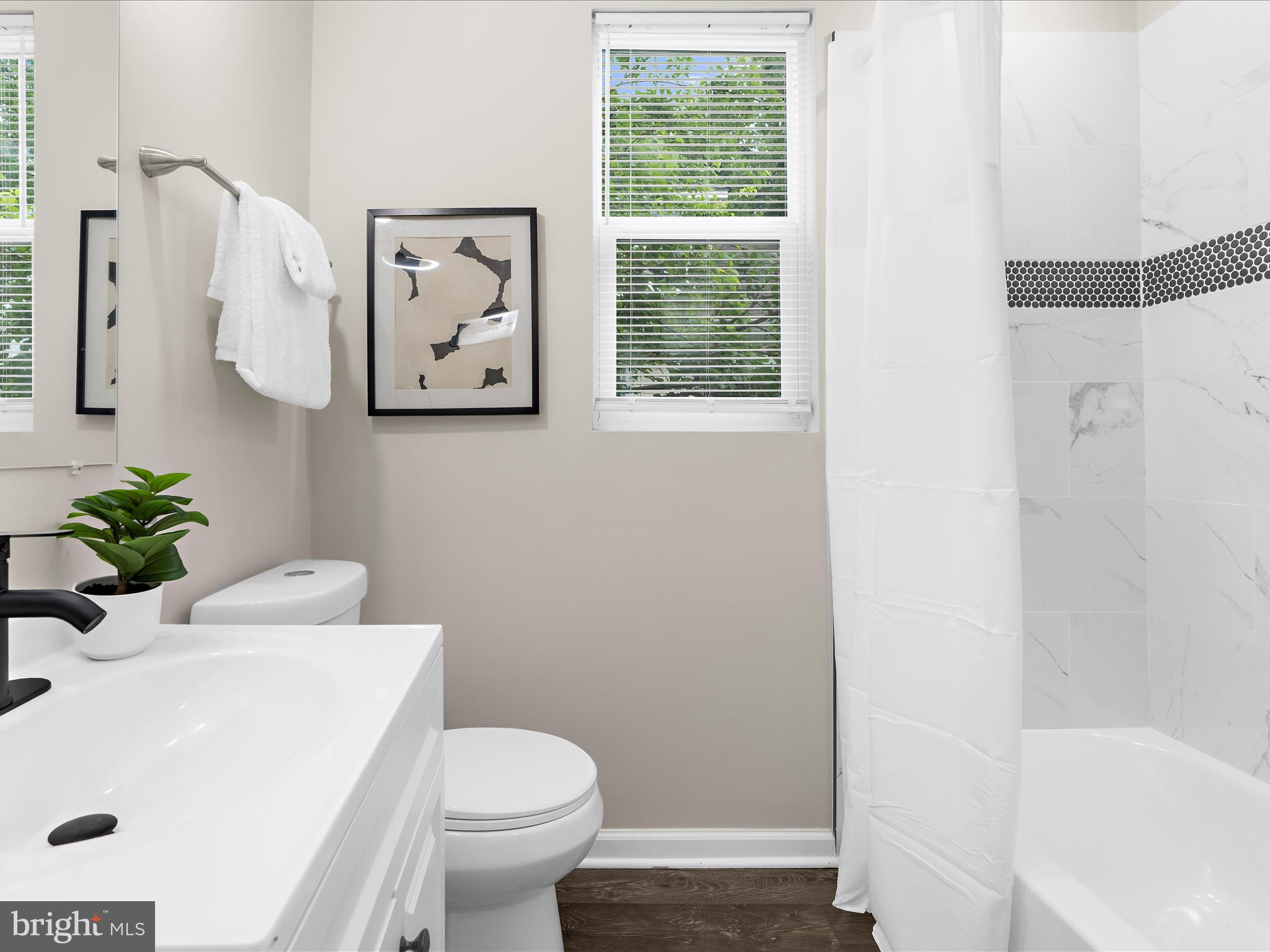 3708 Mohawk Avenue Baltimore, MD 21207 - Photo 35 of 54 a white toilet sitting next to a bathroom sink