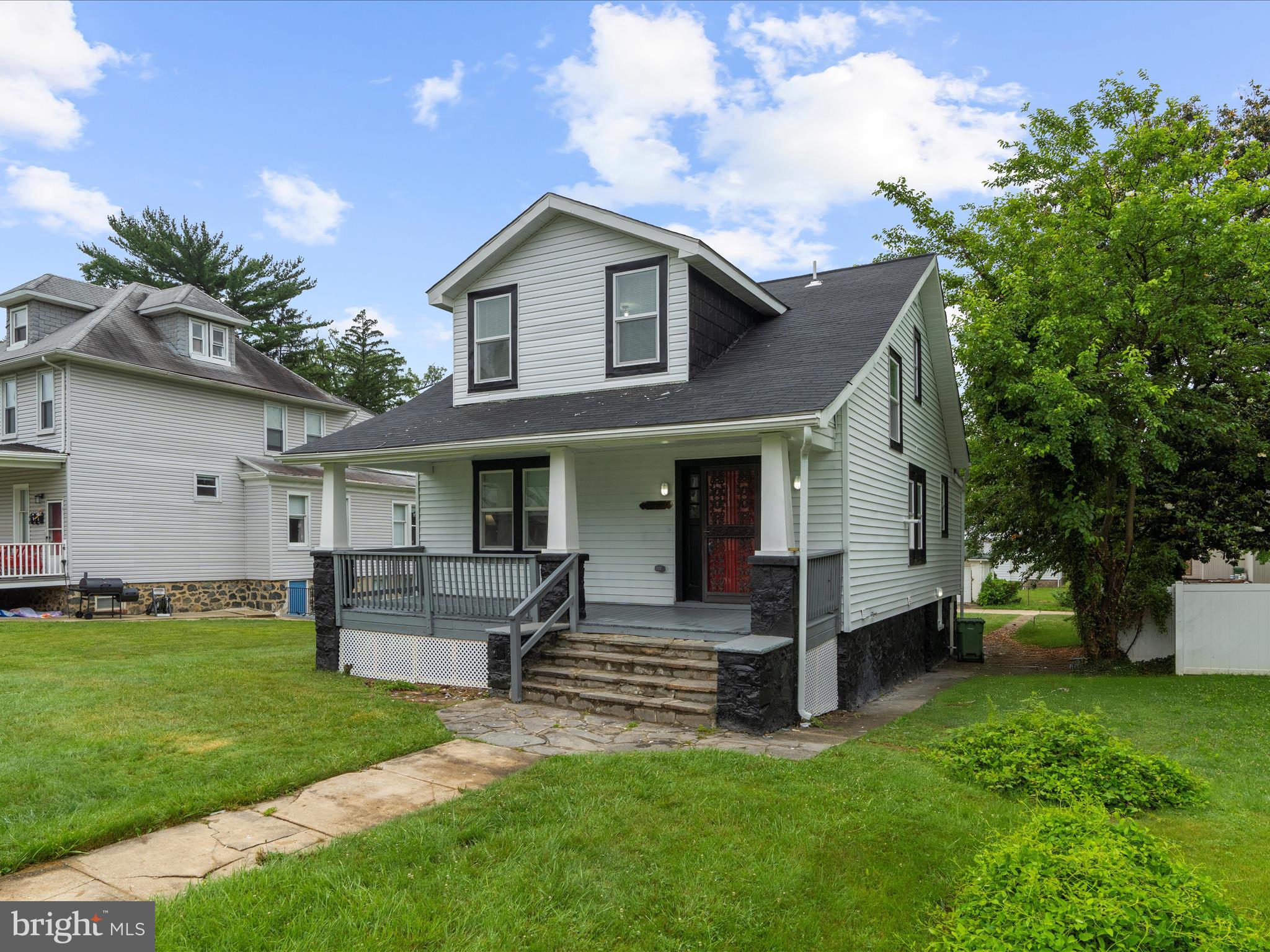 3708 Mohawk Avenue Baltimore, MD 21207 - Photo 47 of 54 a front view of a house with a garden and plants