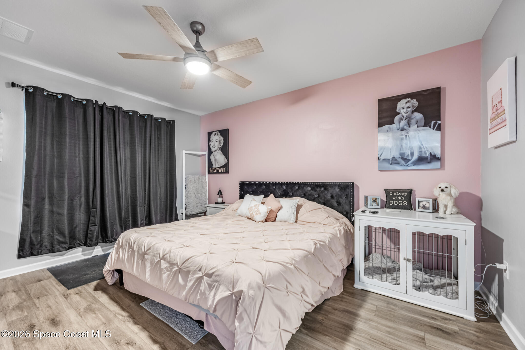 3054 Toulon Road Southeast Palm Bay, FL 32909 - Photo 13 of 30 a bedroom with a large bed and a chandelier