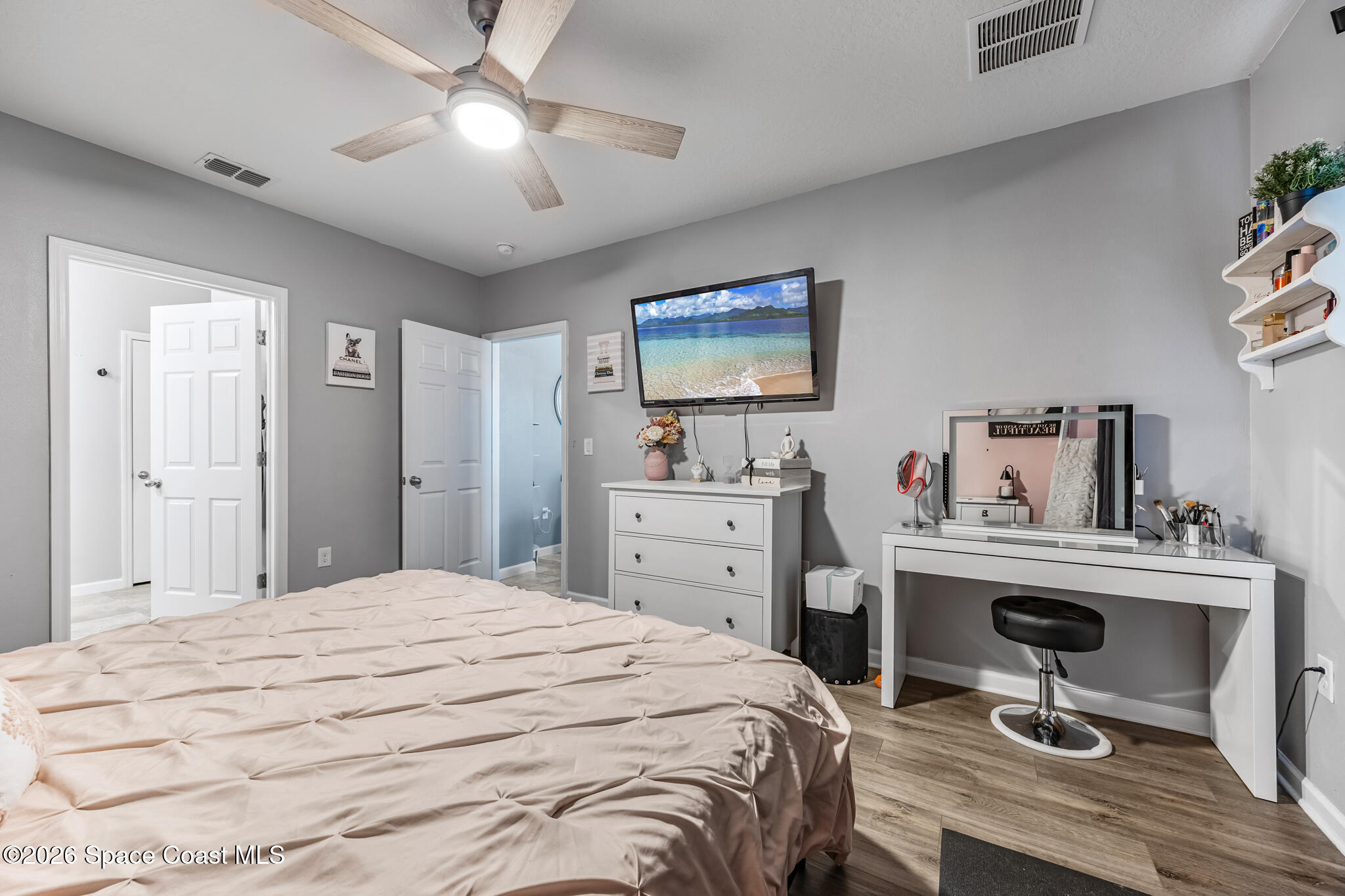 3054 Toulon Road Southeast Palm Bay, FL 32909 - Photo 14 of 30 a bedroom with a bed and a chandelier
