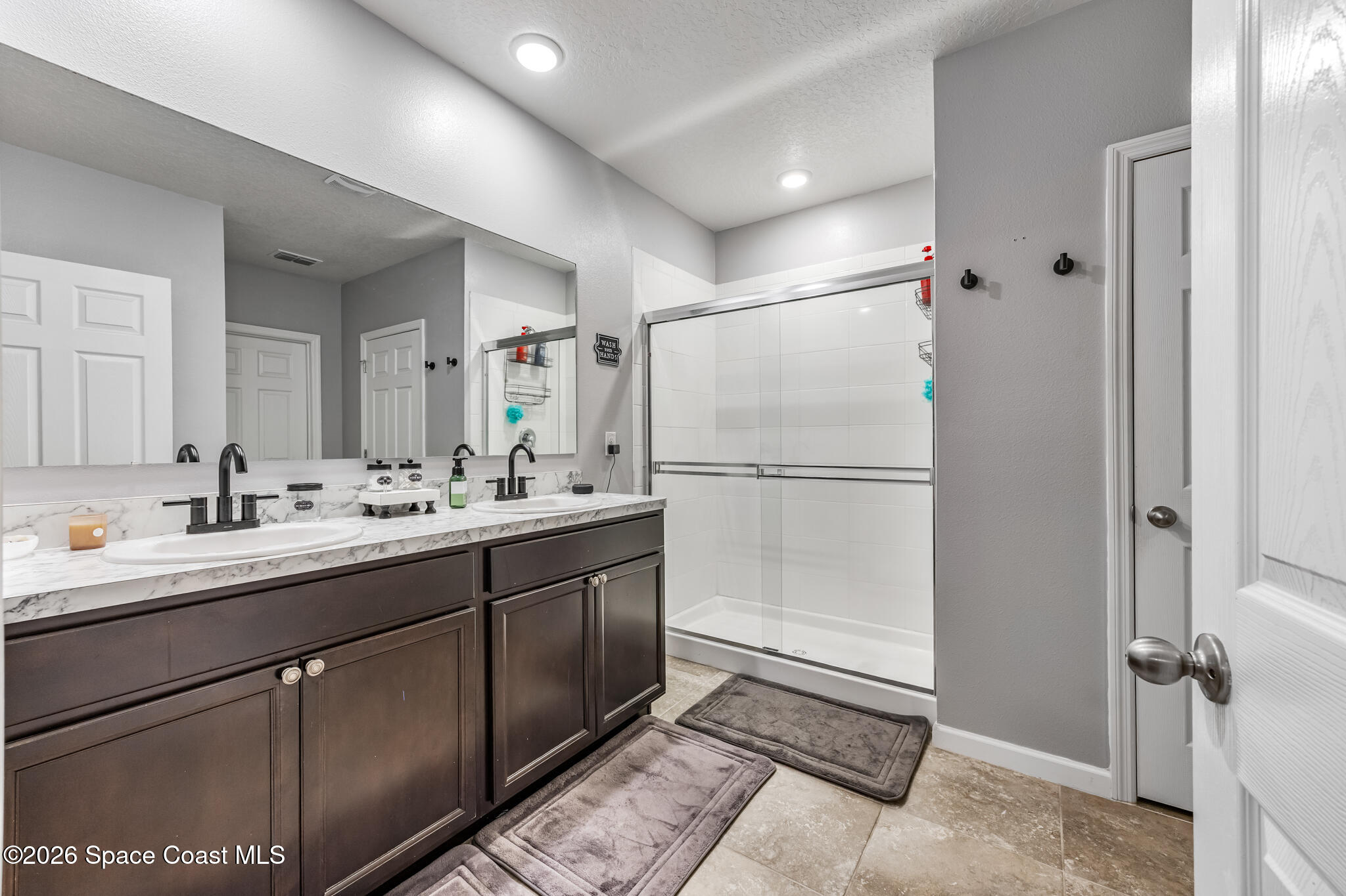 3054 Toulon Road Southeast Palm Bay, FL 32909 - Photo 16 of 30 a bathroom with a double vanity sink and mirror