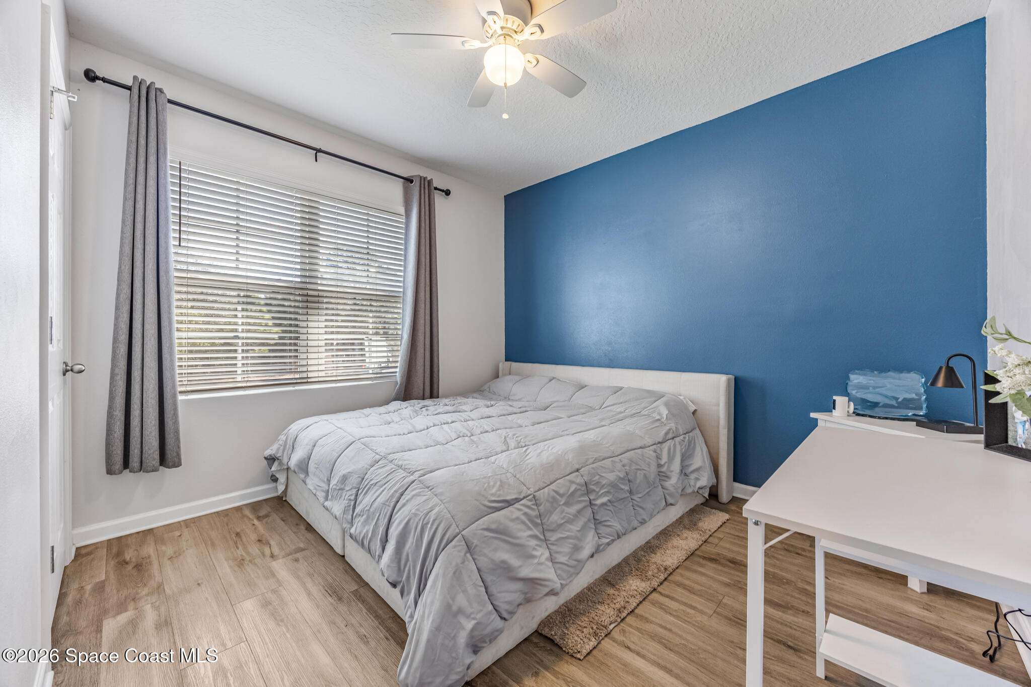 3054 Toulon Road Southeast Palm Bay, FL 32909 - Photo 18 of 30 a bedroom with a bed and a chandelier