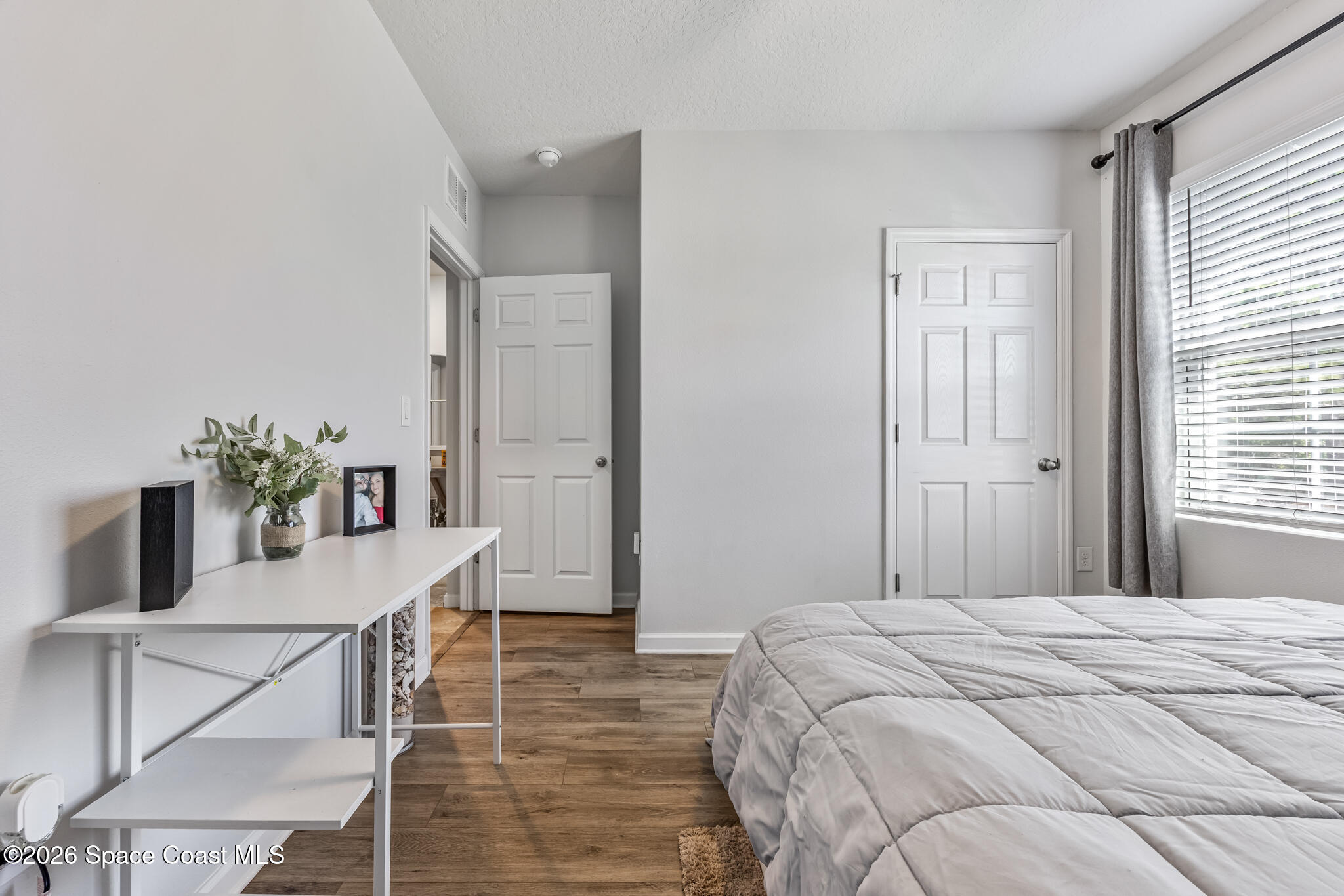 3054 Toulon Road Southeast Palm Bay, FL 32909 - Photo 19 of 30 a bedroom with a bed and a table in it