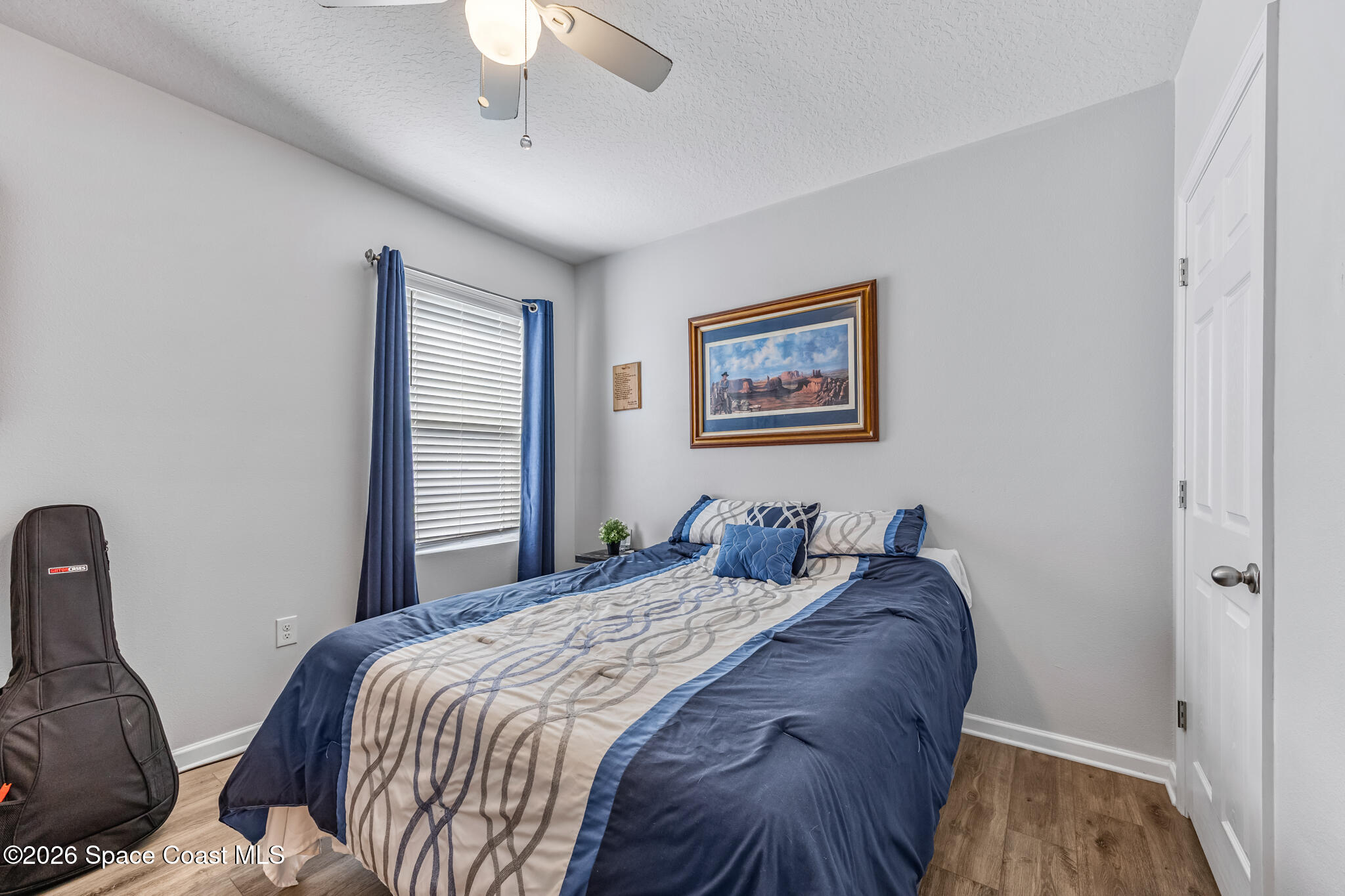 3054 Toulon Road Southeast Palm Bay, FL 32909 - Photo 20 of 30 a bedroom with a bed and a painting on the wall