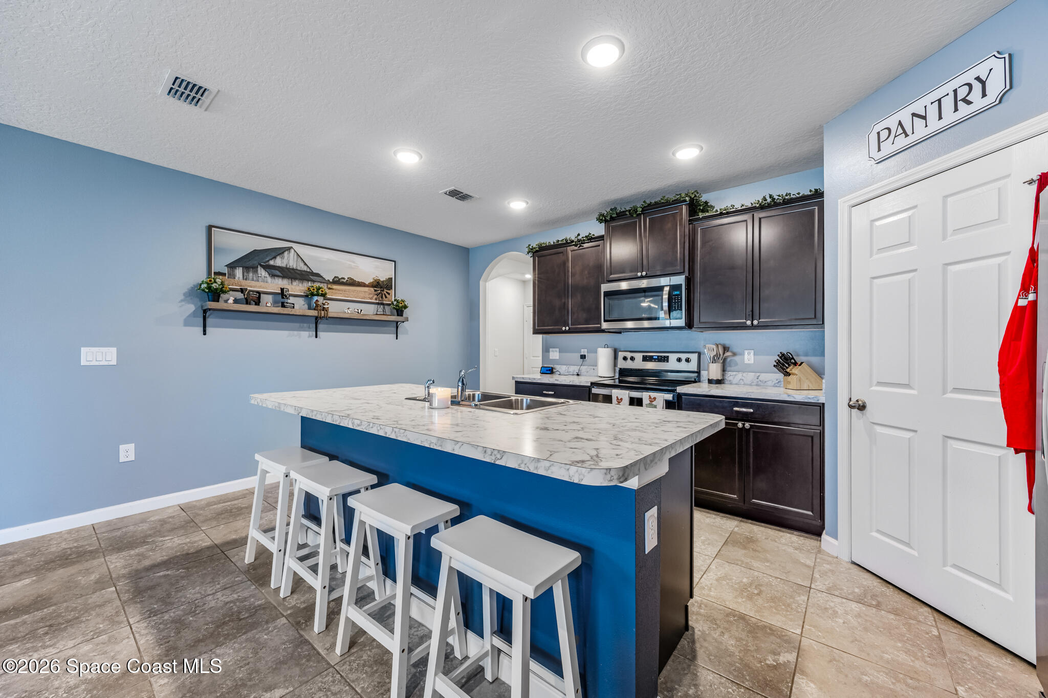 3054 Toulon Road Southeast Palm Bay, FL 32909 - Photo 2 of 30 a kitchen with stainless steel appliances granite countertop a sink stove and refrigerator