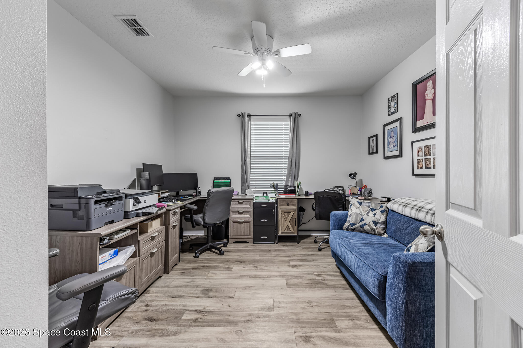 3054 Toulon Road Southeast Palm Bay, FL 32909 - Photo 23 of 30 a living room with furniture and a flat screen tv