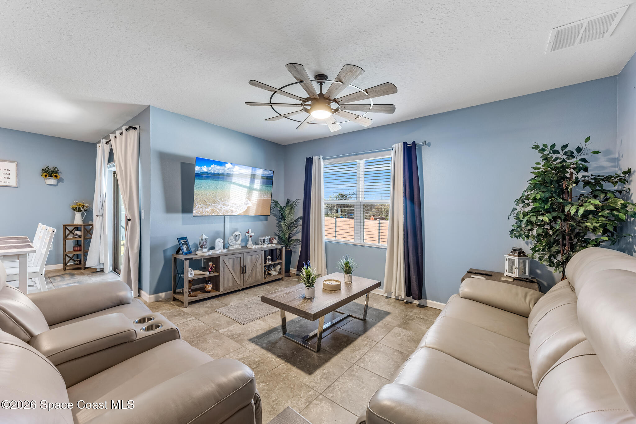 3054 Toulon Road Southeast Palm Bay, FL 32909 - Photo 3 of 30 a living room with furniture and a chandelier