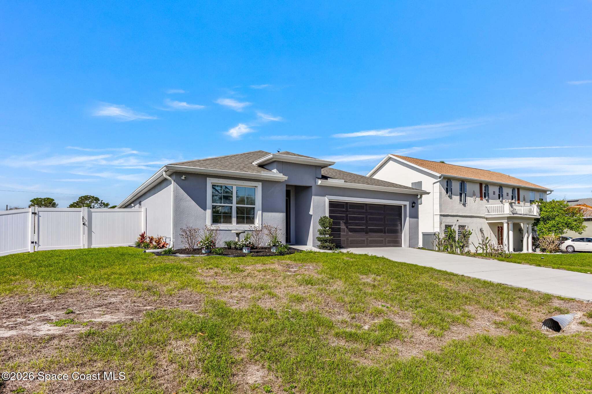 3054 Toulon Road Southeast Palm Bay, FL 32909 - Photo 5 of 30 a view of a house with a yard and garage