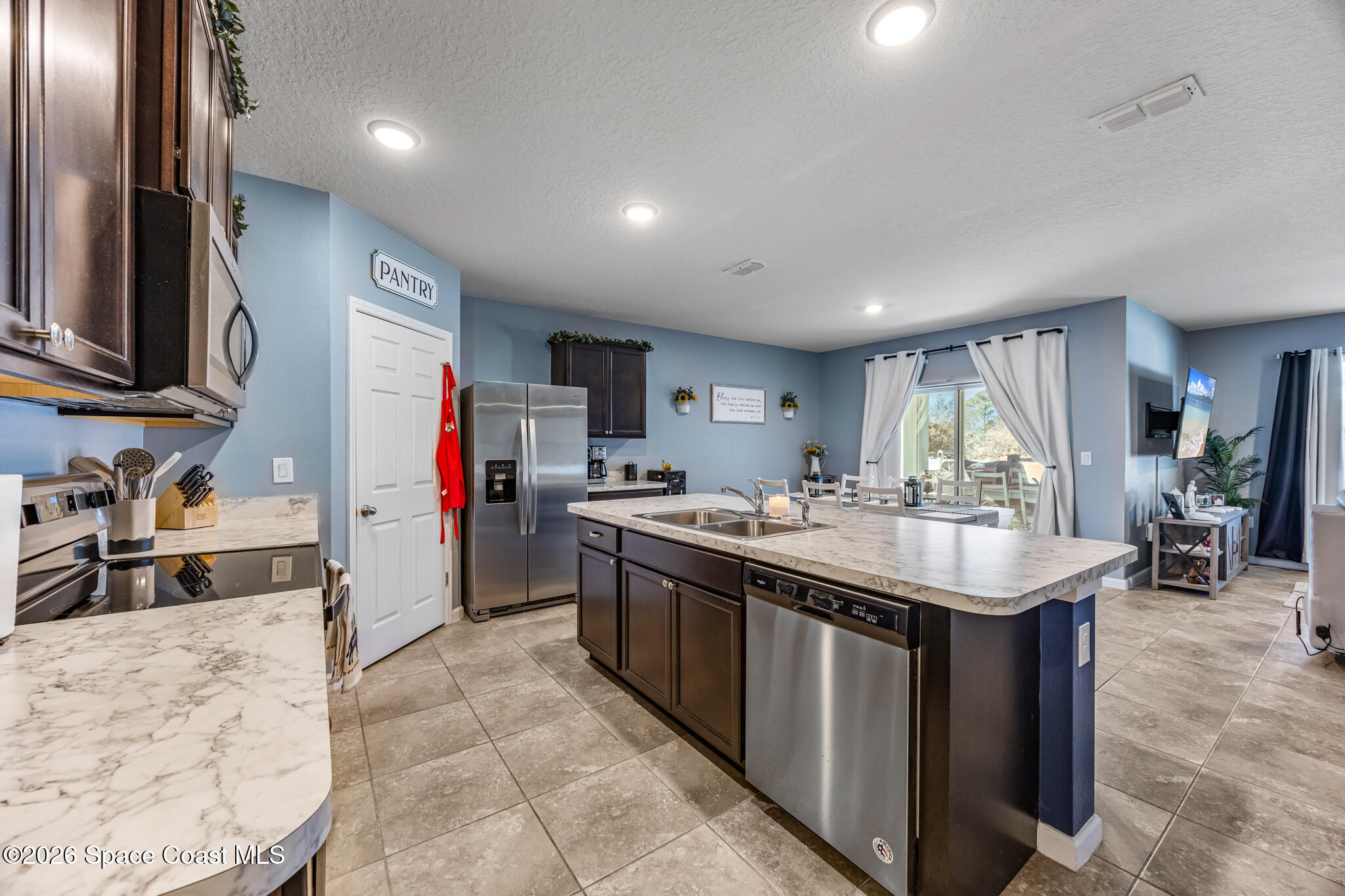 3054 Toulon Road Southeast Palm Bay, FL 32909 - Photo 7 of 30 a kitchen with counter top space sink and center island