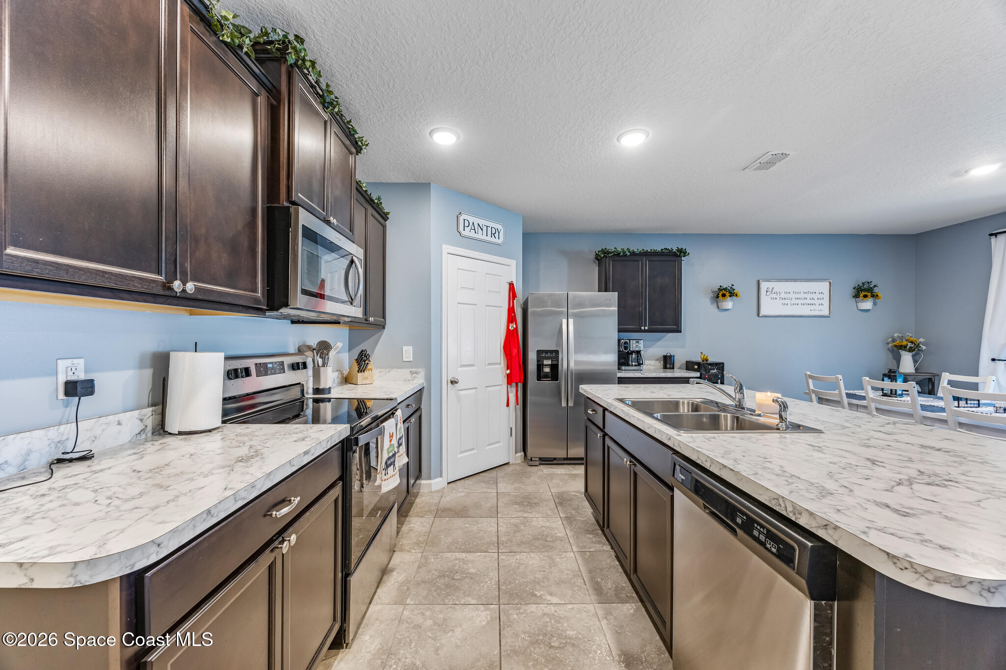 3054 Toulon Road Southeast Palm Bay, FL 32909 - Photo 8 of 30 a kitchen with stainless steel appliances granite countertop a sink stove and refrigerator