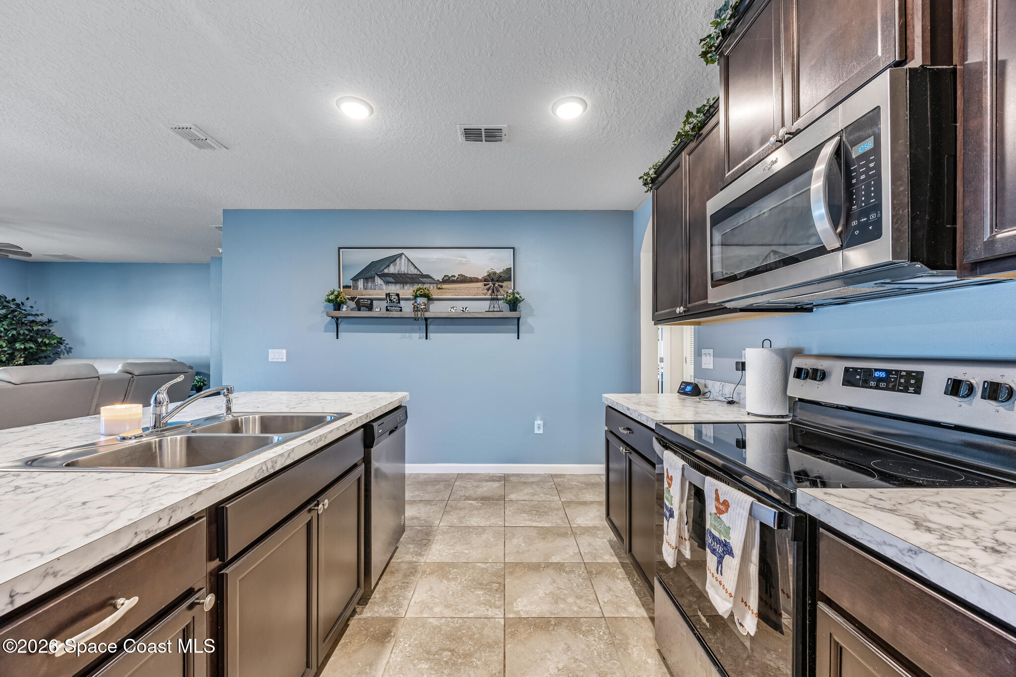 3054 Toulon Road Southeast Palm Bay, FL 32909 - Photo 9 of 30 a kitchen with stainless steel appliances granite countertop a sink and stove