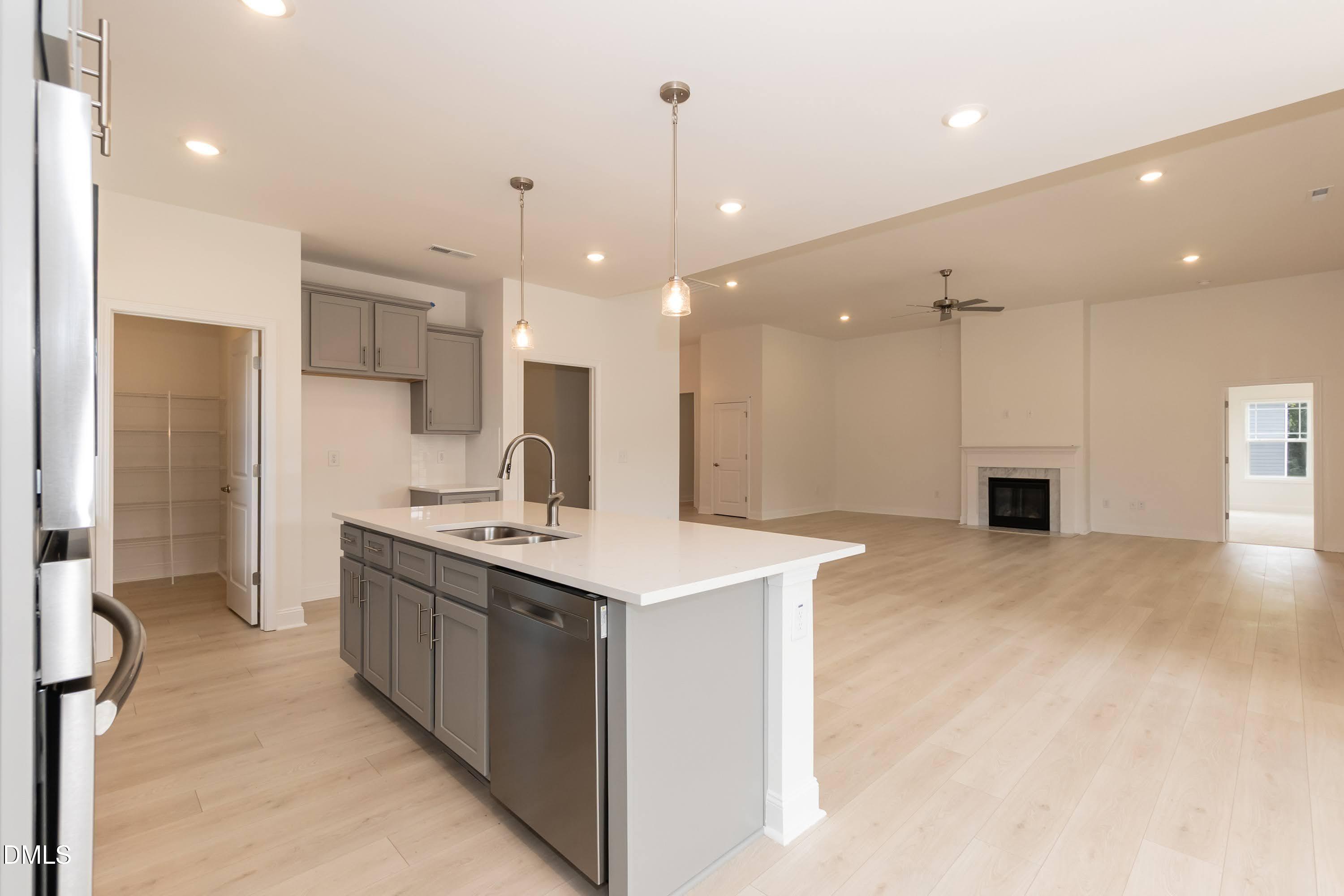 254 Galway Road Lillington, NC 27546 - Photo 12 of 35 a kitchen with a sink a stove a refrigerator and a fireplace