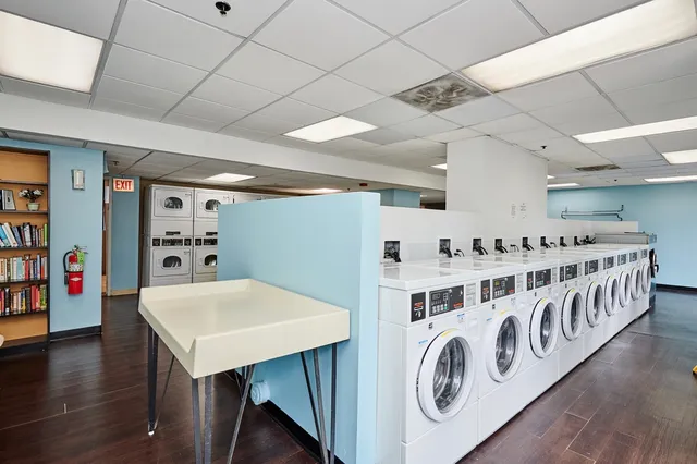 a utility room with stainless steel appliances washer and dryer