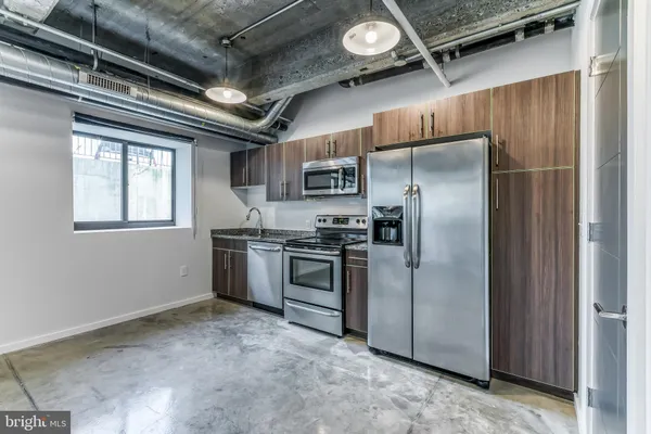 a kitchen with a refrigerator and a stove
