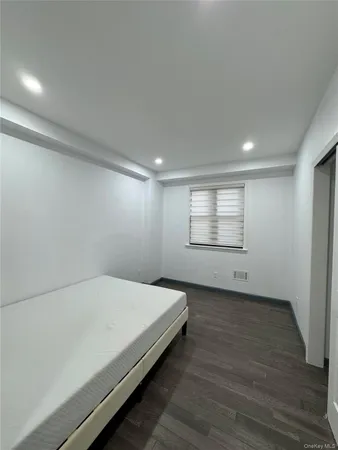 a spacious bedroom with a bed and a window