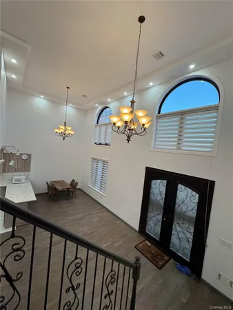 a view of a dining room with furniture wooden floor and chandelier