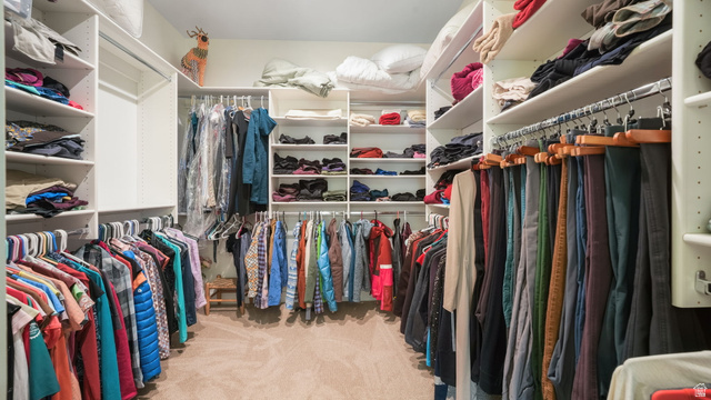 1238 Canyon View Road Midway, UT 84049 - Photo 25 of 36 Walk-in closet featuring built-in shelving, multiple hanging rods, corner shelving units, and carpet flooring