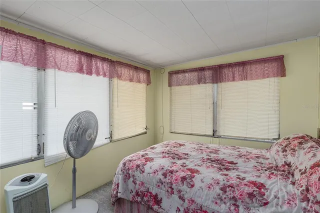 a bedroom with a large bed and a window