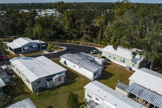 an aerial view of a house with swimming pool and outdoor seating