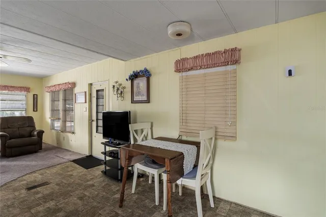 a view of a livingroom with workspace and a couch