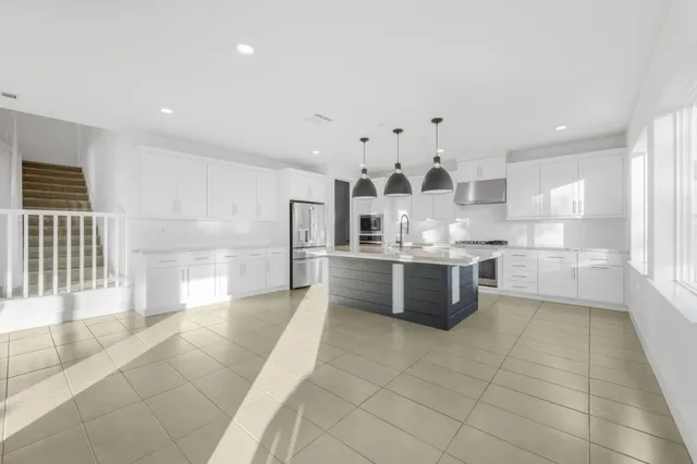 a living room with furniture windows and a flat screen tv