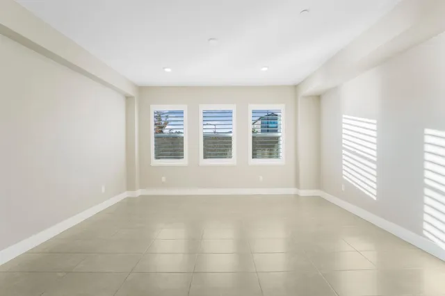 a view of a livingroom with a ceiling fan and window