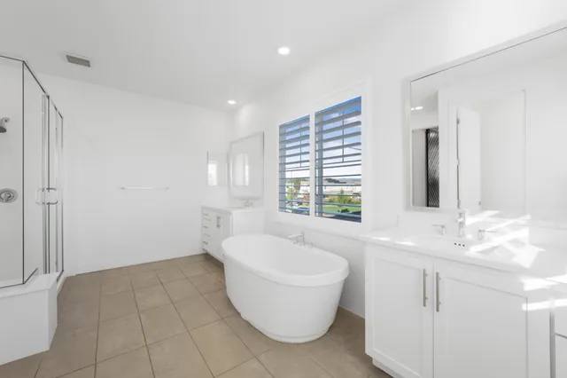 a bedroom with a large bed and a ceiling fan