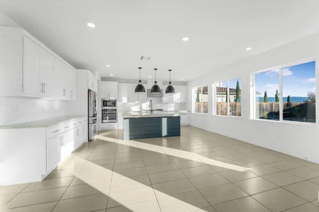 a kitchen with stainless steel appliances granite countertop a sink and a stove