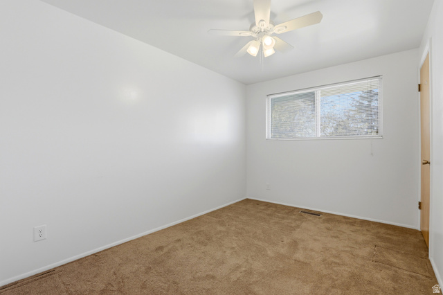 2348 North 770 West Clinton, UT 84015 - Photo 9 of 25 Carpeted room featuring a white ceiling fan with integrated lighting, a window with horizontal blinds, and neutral painted walls
