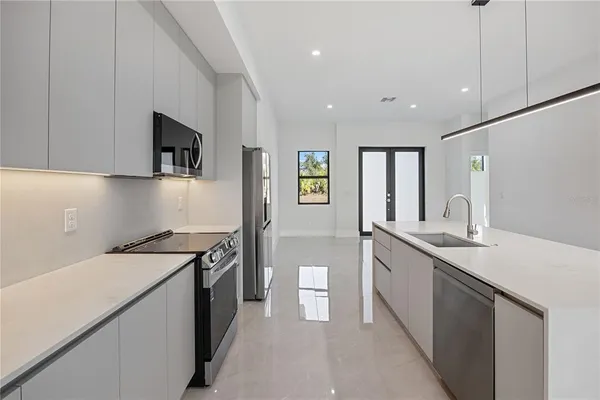 a kitchen with a sink stove and cabinets
