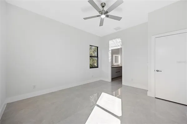 an empty room with closet and windows