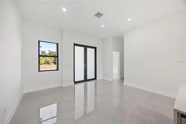 an empty room with windows and closet